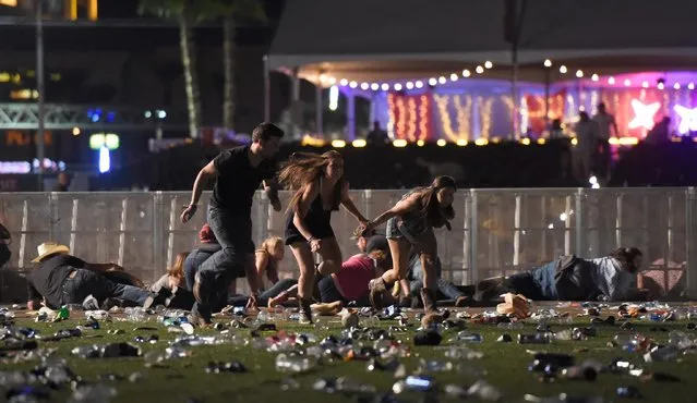 People run from the Route 91 Harvest country music festival after apparent gun fire was heard on October 1, 2017 in Las Vegas, Nevada. There are reports of an active shooter around the Mandalay Bay Resort and Casino. (Photo by David Becker/Getty Images)