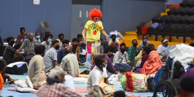 Volunteers from Clownselors perform for stranded migrant workers and homeless people living in Yamuna Sports Complex shelter home during lockdown, on May 10, 2020 in New Delhi, India. (Photo by Raj K Raj/Hindustan Times via Getty Images)