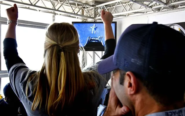 Project team members cheer as Baumgartner leaps out of the space capsule. (Photo by Ross D. Franklin/Associated Press)