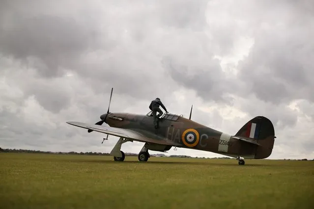 A Hawker Hurricane Mk XIIa 5711 (G-HURI) fighter aircraft returns from performing an aerobatic display at the IWM Duxford on October 18, 2012 in Duxford, England. The aeroplane, similar to those that defended British shores during the Battle of Britain in World War II, is due to be auctioned by Bonhams in their sale of “Collectors' Motor Cars and Automobilia” at Mercedes-Benz World Brooklands on December 3, 2012. The plane was built in 1942 and joined the Royal Canadian Air Force the following year, where it remained for the duration of the war, it is expected to fetch up to 17 million GBP.  (Photo by Oli Scarff)