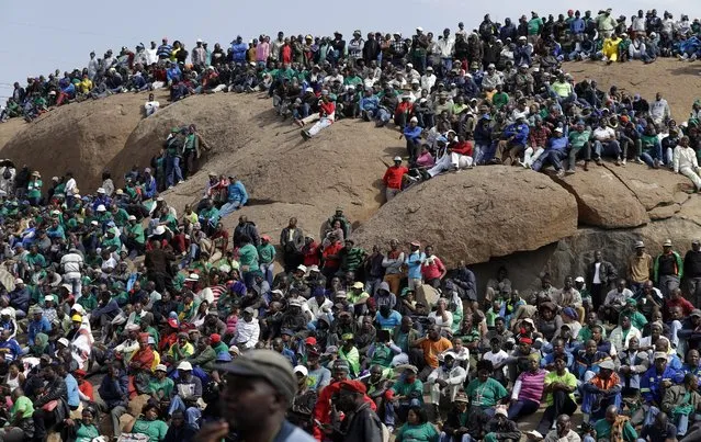 Mine workers sit on a hill during the commemoration near Marikana in Rustenburg, South Africa, Tuesday, August 16, 2016. On August 16, 2012 police shot and killed 34 striking Lonmin miners, apparently while trying to disperse them and end their strike. Ten people, including two police officers and two Lonmin security guards, were killed in the preceding week. (Photo by Themba Hadebe/AP Photo)