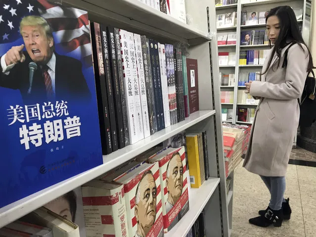 A book with the title “American President Trump” is placed on a shelf for a photo at a section of a book store on foreign leaders in Beijing, China, Tuesday, November 7, 2017. U.S. President Donald Trump's agenda in Beijing this week is expected to be led by the standoff over North Korea's nuclear weapons and demands that China do more to balance trade with America. (Photo by Ng Han Guan/AP Photo)