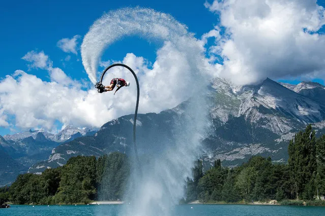 A man rides a flyboard over an artificial small lake at Sion, Switzerland, 21 August 2016. (Photo by Olivier Maire/EPA)