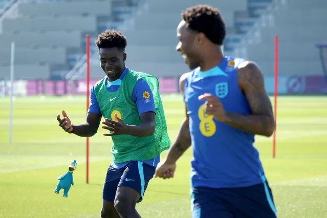 Bukayo Saka and Raheem Sterling of England throw a rubber toy during a training session at Al Wakrah Stadium on November 23, 2022 in Doha, Qatar. (Photo by Eddie Keogh – The FA/The FA via Getty Images)