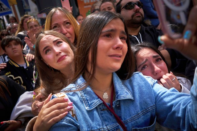 Worshipers react in tears while looking at the Christ of “El Cerro” brotherhood as they process through the streets of Seville, during Holy Week in Spain, Tuesday, April 15, 2025. (Photo by Emilio Morenatti/AP Photo)
