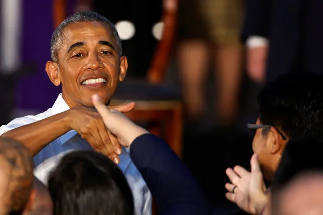 U.S. President Barack Obama greets people as he departs after a town hall-style meeting with a group of Young Southeast Asian Leaders Initiative (YSEALI) attendees, alongside his participation in the ASEAN Summit, at Souphanouvong University in Luang Prabang, Laos September 7, 2016. (Photo by Jonathan Ernst/Reuters)