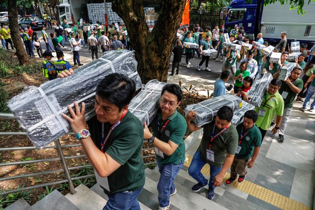 Workers carry official ballots sealed by the Commission on Elections (COMELEC) for storage at city hall in Quezon City, Metro Manila, Philippines, 06 May 2025. Around 68 million Filipinos in the country are expected to cast their votes for national and local-level midterm elections on 12 May, as candidates are campaigning to fill some 18,000 government positions ranging from senators down to local village officers. (Photo by  Rolex dela Peña/EPA/EFE)