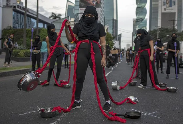 A group of women perform during a protest against the alleged corruption and the lack of measures with a gender perspective, amid the coronavirus pandemic in Panama City, on September 02, 2020. (Photo by Luis Acosta/AFP Photo)