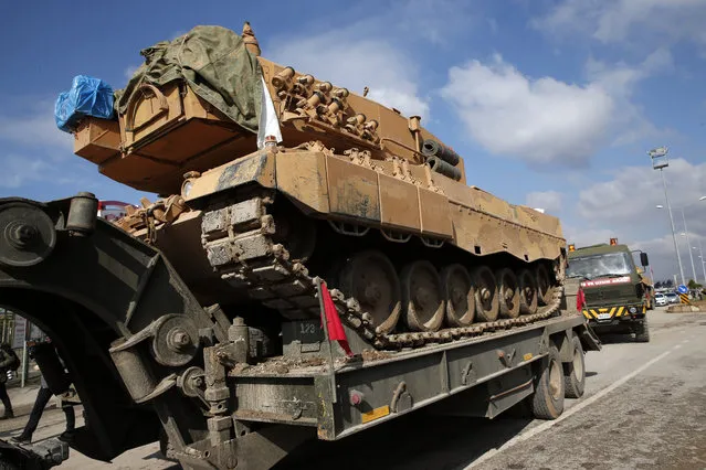 Turkish army tanks cross Oncupinar border gate to enter Syria, in Kilis, Turkey, Saturday, January 27, 2018. Turkey continued to reinforce its military presence in Syria Saturday, a day after the country's president vowed to expand Ankara's operation in a Kurdish enclave in northern Syria eastward toward the Iraqi border. (Photo by Lefteris Pitarakis/AP Photo)