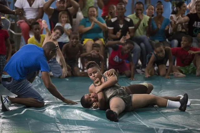 Children fight during a local wrestling tournament in Havana, November 15, 2014. (Photo by Alexandre Meneghini/Reuters)