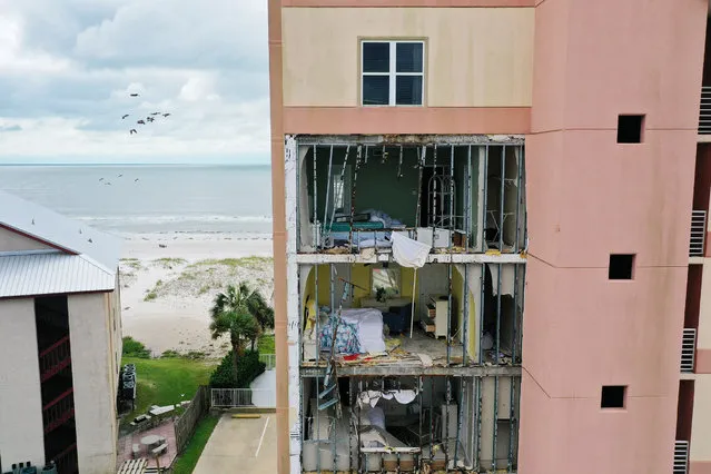 An aerial view from a drone shows an outer wall of the Tropic Isles complex torn off after Hurricane Sally passed through the area on September 17, 2020 in Gulf Shores, Florida. The storm came ashore with heavy rain and high winds. (Photo by Joe Raedle/Getty Images)