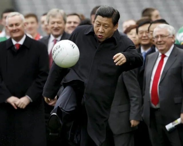 Then China's Vice-President Xi Jinping kicks a football during a visit to Croke Park in Dublin, Ireland, in this February 19, 2012 file photo. Chinese President Xi Jinping heaped praise on Britain for what he called a "visionary and strategic choice" to strengthen commercial ties with China, as he prepared for a state visit to the United Kingdom that's expected to be richer in pomp and considerably warmer in tone than his recent trip to the United States. (Photo by David Moir/Reuters)