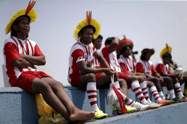 Indigenous people from the Kayapo tribe watch a soccer match during I World Games for Indigenous People in Palmas, Brazil, October 22, 2015. (Photo by Ueslei Marcelino/Reuters)
