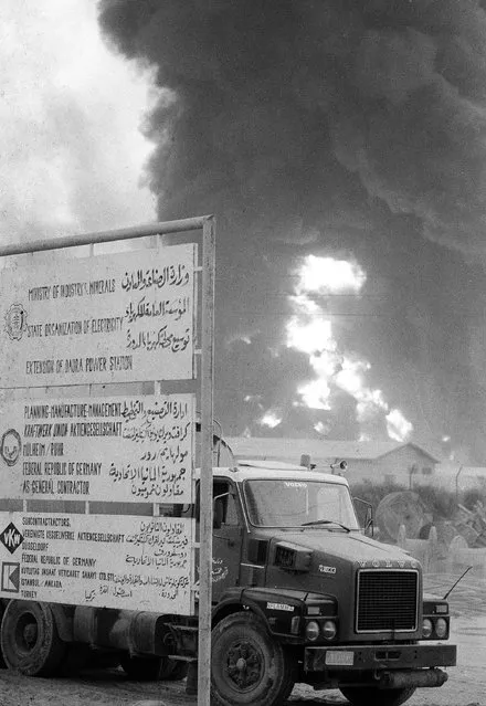 An Iraqi tanker leaves the electricity plant near Baghdad, Iraq, while a bombing raid destroyed the plant, in background, October 3, 1980. Israel said the suggestion that it was involved in the bombing raid on Iraq's electric plant was “an antisemitic blood libel”. The bombing raid killed 10 people and wounded approximately 80. (Photo by Jacques Langevin/AP Photo)