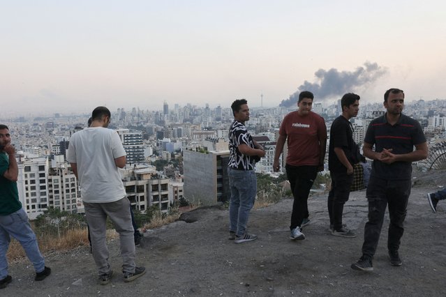 Men react as smoke rises following an Israeli attack on the IRIB building, the country's state broadcaster, in Tehran, Iran on June 16, 2025. (Photo by Majid Asgaripour/WANA via Reuters)
