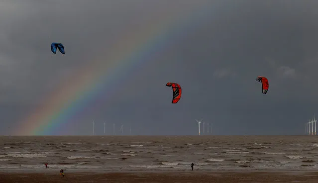 Kite surfers are pictured in front of the Burbo Bank offshore wind farm near New Brighton, Britain, October 6, 2020. (Photo by Phil Noble/Reuters)