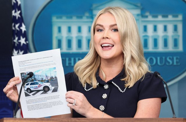 White House Press Secretary Karoline Leavitt holds up a printed out copy of The Washington Post article from 2024 with results of a poll on public safety in D.C., during a briefing in Washington on August 12, 2025. (Photo by Kevin Lamarque/Reuters)