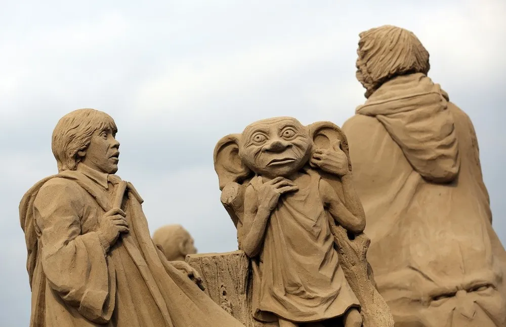 Sculptors Place the Finishing Touches to Their Hollywood Themed Sand Sculptures
