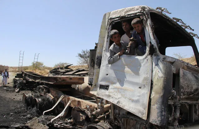 Boys play in an oil tanker truck, a day after it was hit by a Saudi-led air strike near the northwester city of Saada, Yemen October 8, 2016. (Photo by Naif Rahma/Reuters)