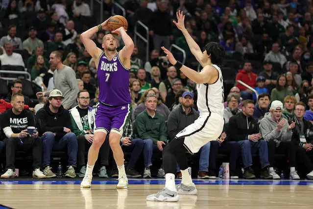 Joe Ingles #7 of the Milwaukee Bucks shoots over Yuta Watanabe #18 of the Brooklyn Nets during the first half of a game at Fiserv Forum on March 09, 2023 in Milwaukee, Wisconsin. (Photo by Stacy Revere/Getty Images)