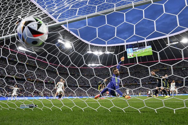Germany's Jamal Musiala, right, scores his side's second goal during the Group A match between Germany and Scotland at the Euro 2024 soccer tournament in Munich, Germany, Friday, June 14, 2024. Germany, the host nation, won 5-1. (Photo by Federico Gambarini/dpa via AP Photo)