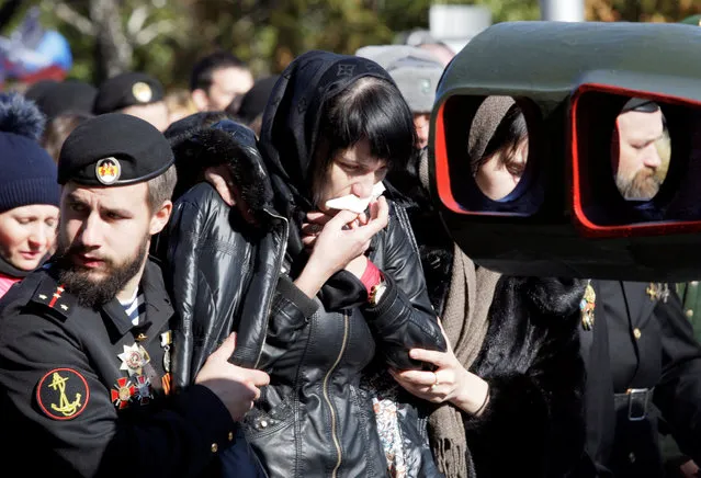 Yelena Pavlova mourns as she attends the funeral of her husband Russian separatist commander Arseny Pavlov, known by the nom de guerre “Motorola”, who was blown up in the lift of his apartment building on October 16, in Donetsk, Ukraine, October 19, 2016. (Photo by Alexander Ermochenko/Reuters)