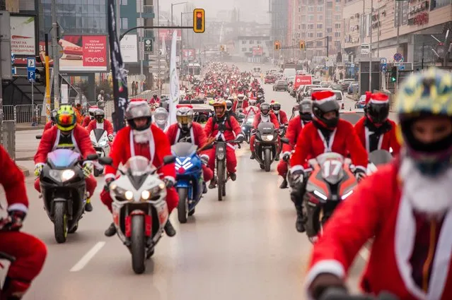 Hundreds of people dressed as Santa Claus are seen during a Christmas ride on December 19, 2020 in Sofia, Bulgaria. The Christmas Ride is an annual tradition for Sofia's motorcyclists. In previous years they would end the parade by bringing gifts to children in orphanages, this was not possible this year due to the Covid-19 restrictions. (Photo by Hristo Rusev/Getty Images)