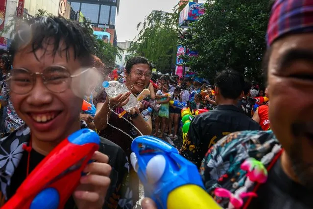 People play with water as they celebrate the Songkran holiday which marks the Thai New Year in Bangkok, Thailand on April 13, 2023. (Photo by Athit Perawongmetha/Reuters)