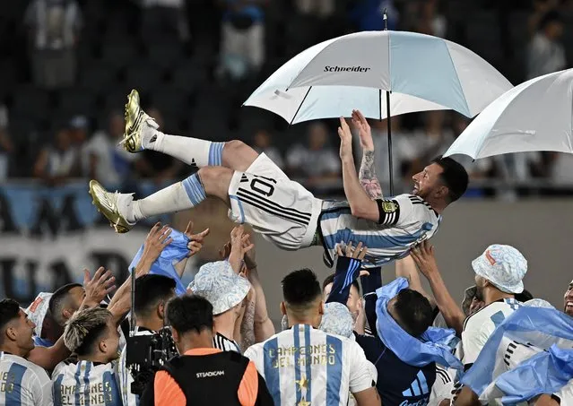Argentina's forward Lionel Messi is lifted up by teammates during a recognition ceremony for the World Cup winning players, following the friendly football match between Argentina and Panama at the Monumental stadium in Buenos Aires on March 23, 2023. (Photo by Luis Robayo/AFP Photo)