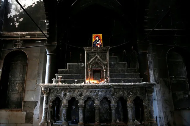 The damaged altar in the Grand Immaculate Church seen after the church was recaptured from Islamic State in Qaraqosh, near Mosul, Iraq, October 30, 2016. (Photo by Ahmed Jadallah/Reuters)