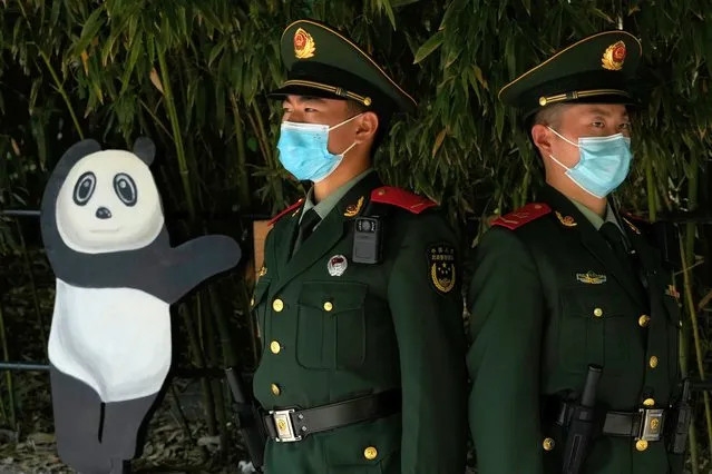 Chinese paramilitary policemen guard an entrance to the Panda enclosure in the zoo on the last day of the May Day holidays in Beijing, Wednesday, May 3, 2023. (Photo by Ng Han Guan/AP Photo)