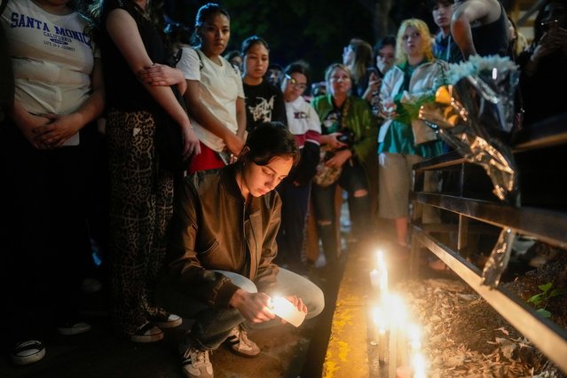 Fans light candles outside the hotel where former One Direction singer Liam Payne was found dead after he fell from a balcony in Buenos Aires, Argentina, Wednesday, October 16, 2024. (Photo by Natacha Pisarenko/AP Photo)
