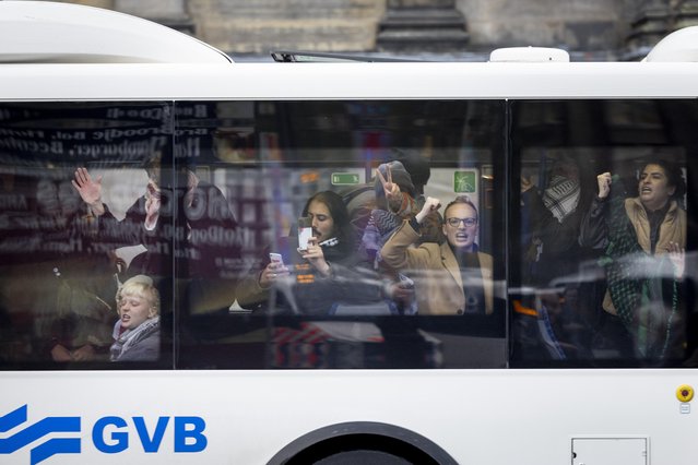 Demonstrators are carried off by police in a bus after a pro-Palestinian protest in Dam Square in Amsterdam, the Netherlands, 10 November 2024. The protest took place while an emergency ordinance and demonstration ban are in place in the city. These measures were previously deployed following tensions and violence involving supporters of Israeli soccer club Maccabi Tel Aviv after a soccer match at Ajax on 07 November 2024. (Photo by Robin van Lonkhuijsen/EPA)