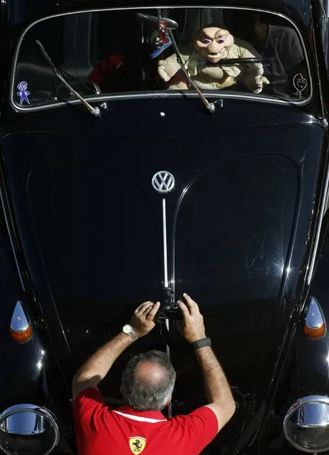 A visitor takes a photograph during a Volkswagen Beetle owners' meeting in Sao Bernardo do Campo January 25, 2015. (Photo by Paulo Whitaker/Reuters)