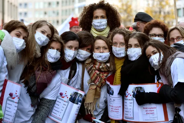 Demonstrators dressed as nurses pose for the photographer as they take part in a rally organized by Belgian public health, social and cultural sectors workers in central Brussels, Belgium November 24, 2016. (Photo by Eric Vidal/Reuters)