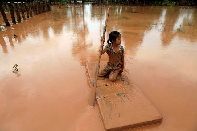 A girl uses a mattress as a raft during the flood after the Xepian-Xe Nam Noy hydropower dam collapsed in Attapeu province, Laos, July 26, 2018. (Photo by Soe Zeya Tun/Reuters)