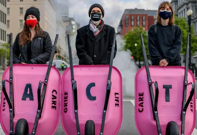 Extinction Rebellion DC blocks 17th Street after dumping cow manure outside the White House on Earth Day to protest President Biden's climate plan in Washington, U.S., April 22, 2021. (Photo by Evelyn Hockstein/Reuters)