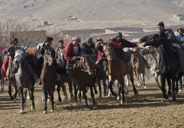 Afghan horse riders compete for the goat during a friendly buzkashi match on the outskirts of Kabul, Afghanistan, Thursday, January 15, 2015. (Photo by Massoud Hossaini/AP Photo)