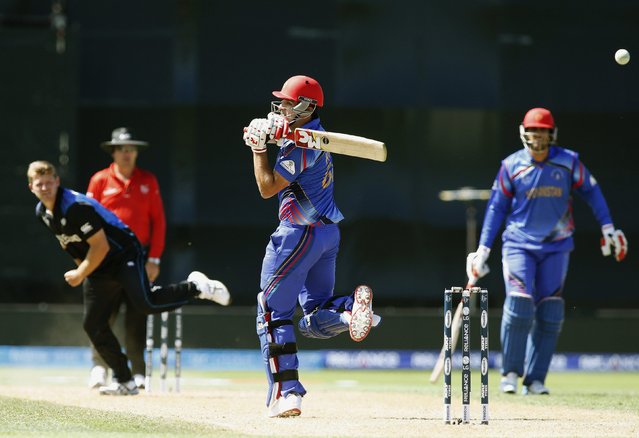 Afghanistan's Hamid Hassan swings the ball away from New Zealand's Corey Anderson (L) during their Cricket World Cup match in Napier, March 8, 2015. REUTERS/Nigel Marple (NEW ZEALAND - Tags: SPORT CRICKET)