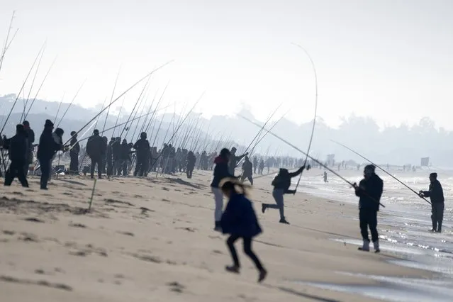 Fishermen compete in the Brotola Fishing Contest at Las Toscas beach, Uruguay, Sunday, July 3, 2022. More than 500 fishermen competed in the contest. (Photo by Matilde Campodonico/AP Photo)