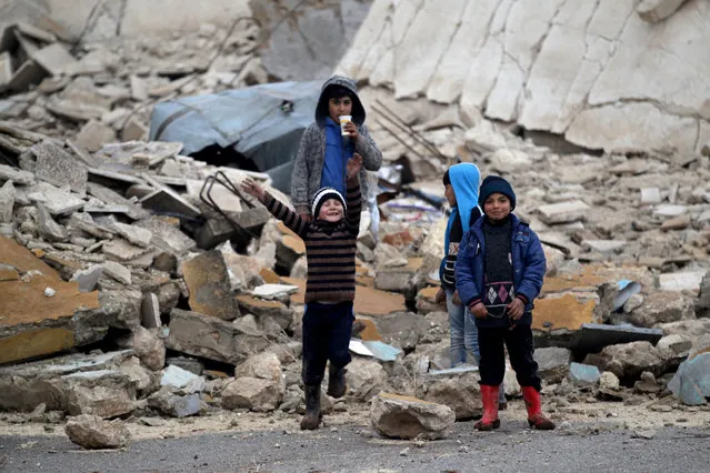 Children play near rubble of damaged buildings in al-Rai town, northern Aleppo countryside, Syria December 25, 2016. (Photo by Khalil Ashawi/Reuters)