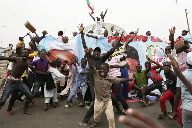 Residents celebrate the anticipated victory of Presidential candidate Muhammadu Buhari  in Kaduna,  Nigeria Tuesday, March 31, 2015. (Photo by Jerome Delay/AP Photo)