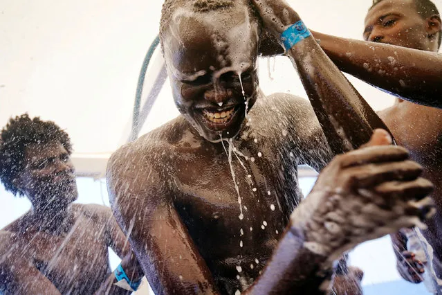 Chuol, 17, from Sudan, takes a shower on board the Spanish NGO Proactiva Open Arms rescue boat in the Mediterranean Sea, August 3, 2018. (Photo by Juan Medina/Reuters)