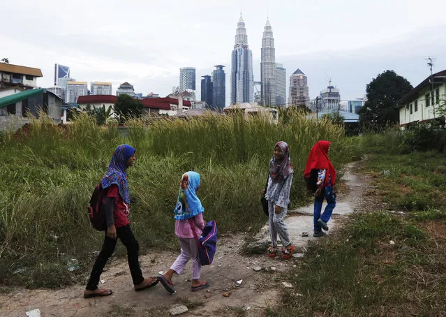 Girls make their way home after school in Kuala Lumpur, Malaysia, February 10, 2016. (Photo by Olivia Harris/Reuters)