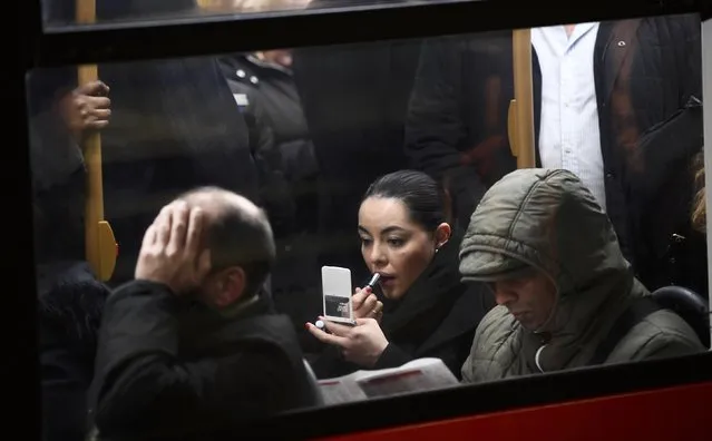 A woman applies her makeup on a packed bus during a strike on the Underground by members of two unions in protest at ticket office closures and reduced staffing levels, in London, Britain January 9, 2017. (Photo by Dylan Martinez/Reuters)