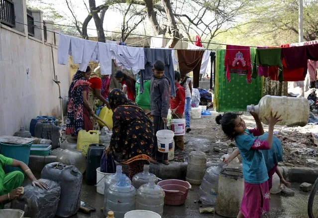 Residents fill water in their containers from a municipal tap in New Delhi, India, February 21, 2016. (Photo by Anindito Mukherjee/Reuters)