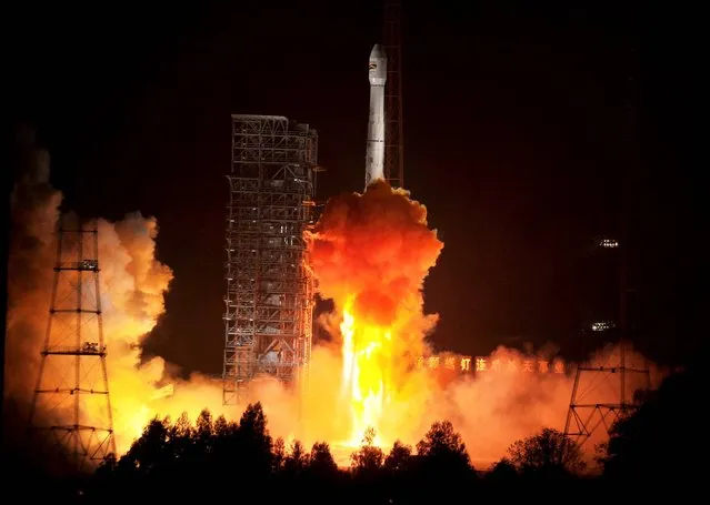 In this photo released by China's Xinhua News Agency, a Bolivian communications satellite is launched from the Xichang Satellite Launch Center(XSLC) in Xichang, southwest China's Sichuan Province, Saturday, December 21, 2013. (Photo by Yan Yan/AP Photo/Xinhua)