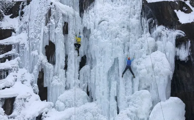 People take part in a regional ice climbing and winter rock climbing championship at the “Stolby” (Rock Pillars) national natural reserve, with the air temperature at about minus 18 degrees Celsius (minus 0.4 degrees Fahrenheit), outside Krasnoyarsk, Siberia, Russia January 14, 2017. (Photo by Ilya Naymushin/Reuters)
