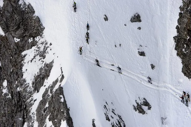 Touring skiers climb during the 68th edition of the “Trophees du Muveran” a Ski Mountaineering race through the Swiss Alps, near Les Plans-sur-Bex, Switzerland, Sunday, April 12, 2015. (Photo by Jean-Christophe Bott/AP Photo/Keystone)