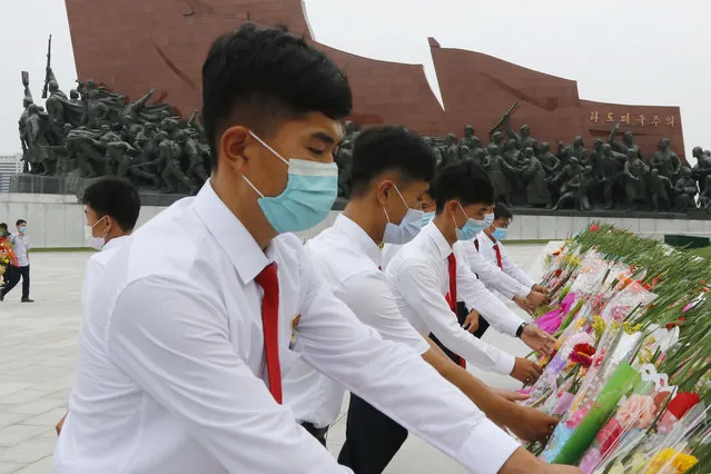 Pyongyang citizens visit Mansu Hill to pay homage to the bronze statues of President Kim Il Sung and Chairman Kim Jong Il ahead of the 27th anniversary of the death of President Kim Il Sung, in Pyongyang, North Korea, on Wednesday, July 7, 2021. (Photo by Cha Song Ho/AP Photo)